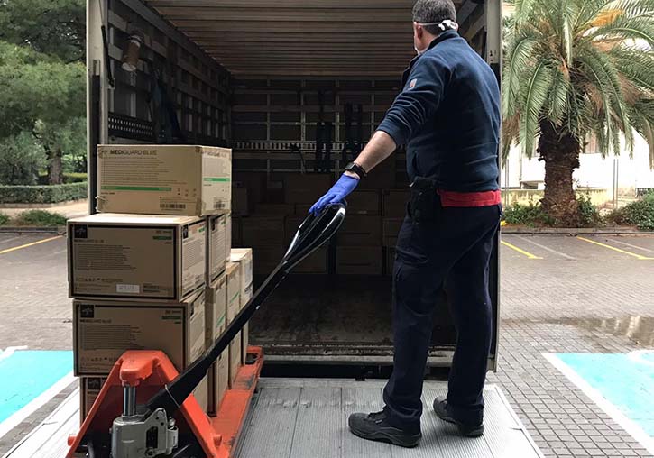 A snapshot of a man loading the material for the Valencian government (Generalitat Valenciana) to prevent the spread of Coronavirus COVID-19.